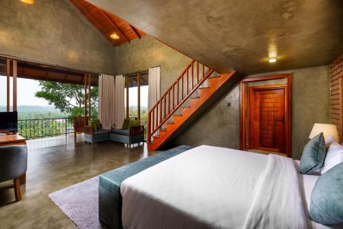 a bedroom with a bed and a staircase at Villa Rumassala Luxury Chalets Unawatuna in Unawatuna