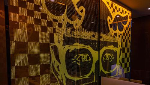 a wall with a painting of a face on it at art'otel London Hoxton in London