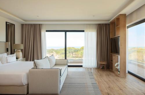 a hotel room with a bed and a couch at Meliá Durrës Albania in Durrës
