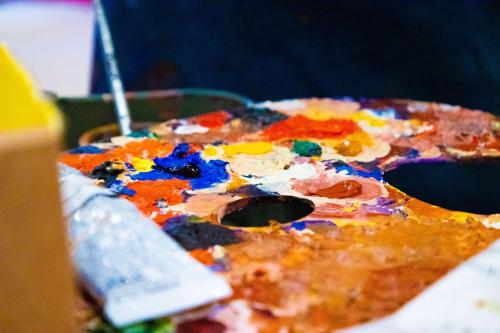 a pizza covered in colorful paint on a table at art'otel London Hoxton in London