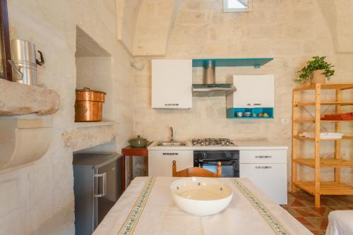 a kitchen with a table with a bowl on it at La casa a corte con terrazzo - Artemisia Homes in Spongano