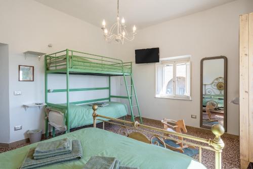 a bedroom with two bunk beds and a mirror at Bed and Breakfast Mea Familia in Vinci