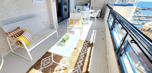 a balcony with a bench and a table and chairs at Sea View Appartement Blue Monkey in Ifach
