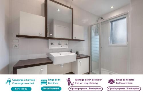 a white bathroom with a sink and a mirror at Maison rénovée pour 8 - 200m Tharon plage in Tharon-Plage
