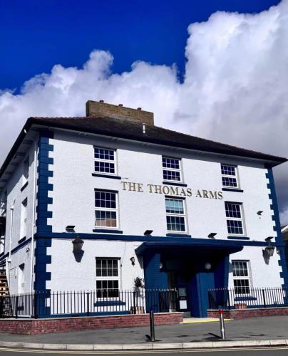 a white building with the honors arms written on it at Thomas Arms Hotel in Llanelli