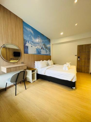 a hotel room with a large bed and a mirror at New Siam II in Bangkok
