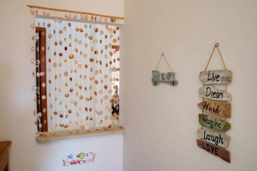 a white refrigerator with magnets on a wall at Sardinianworld - Josto Panoramic House in S'archittu Cuglieri
