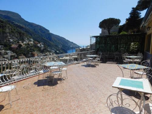 a group of tables and chairs on a patio at Villaverde in Positano