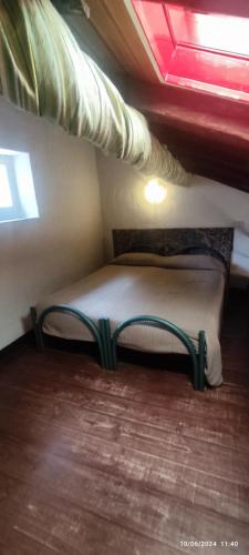 a small bed in a room with a ceiling at Bike NIGHT-bike friendly, cozy loft, Finale Ligure in Finale Ligure