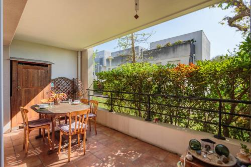 un patio avec une table et des chaises sur un balcon dans l'établissement Appartement Pont Pierre - Welkeys, à Bayonne