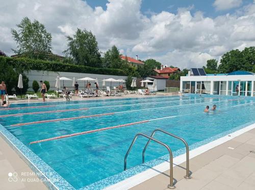 a large swimming pool with people in the water at Хостел Спортна база Ветрен in Burgas City