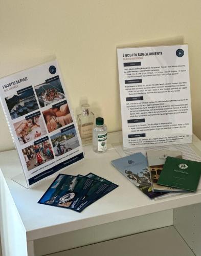 a table with two pamphlets on top at Feriolo Nautique Apartments in Baveno