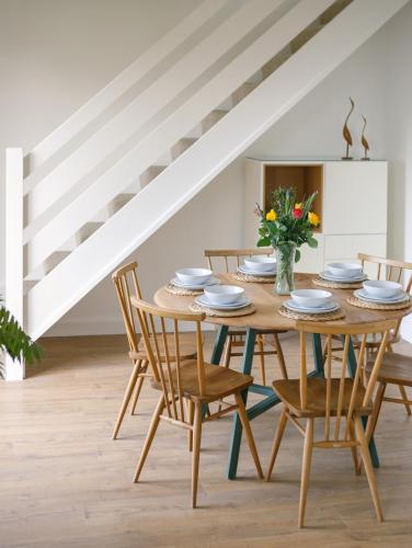 a dining room with a wooden table and chairs at No 26 The perfect Brighton Getaway in Brighton & Hove