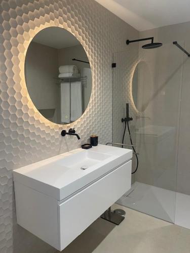 a bathroom with a white sink and a mirror at Estrela Santa Ana Cova da Iria in Fátima