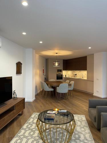 a living room with a table and a dining room at Estrela Santa Ana Cova da Iria in Fátima