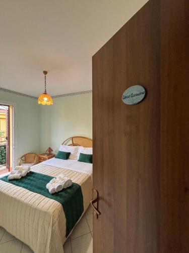 a bedroom with a bed and a wooden door at Aspra Mare House in Aspra