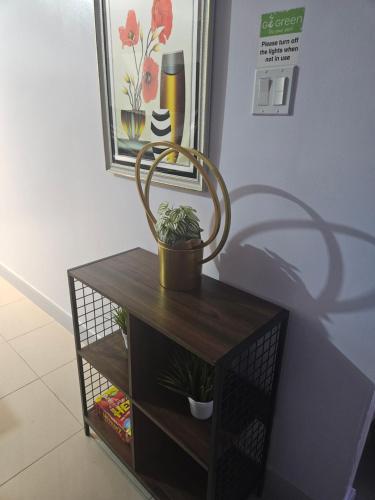 a small table with a plant on top of it at Summer Breeze Villa in Lucea