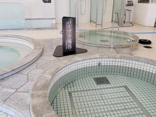 two large pools of water in a building at LiVEMAX RESORT Hakodate Greenpia Onuma in Mori