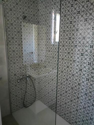 a bathroom with a shower with a glass door at Brisas del Lago in Navarrés