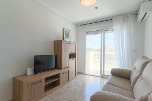 a living room with a tv and a couch at 099 - Parque y playa 007 - comfortHOLIDAYS in Santa Pola