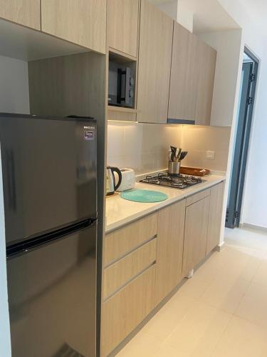 a kitchen with a refrigerator and a stove in it at Colombo, Trizen Luxury Apartments, Sri Lanka in Colombo