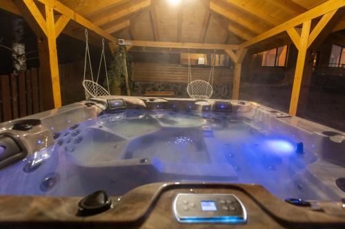 a jacuzzi tub in a wooden house at Casa Rustică in Călăţele