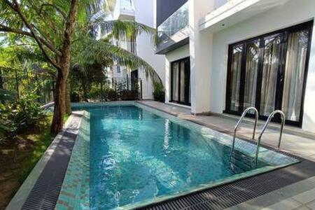 a swimming pool in front of a building at Peacock View 4 BHK Pvt Pool & Jacuzzi at Saligao in Saligao