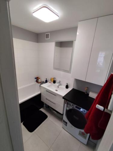 a small kitchen with a sink and a stove at Sweet Apartament 6 osobowy in Płock