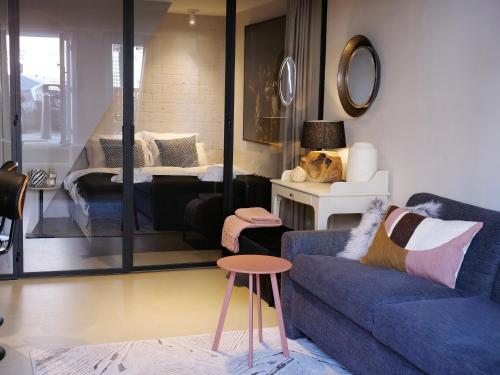 a living room with a blue couch and a table at CANAL APARTMENT AMSTERDAM CENTRAL 4p in Amsterdam