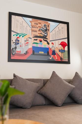 a painting hanging on a wall above a couch at VELA be Bangkok Siam in Bangkok