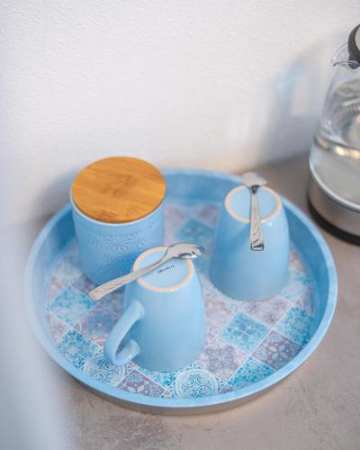 a blue plate with two cups and a wooden spoon at La Vedetta in Luras