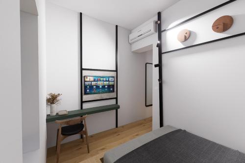 a bedroom with a bed and a desk and a window at Kentrikon 1924 Boutique Hotel, Paphos Old Town in Paphos City