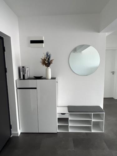 a white room with a mirror and a white cabinet at Apartment Cluj, Baciu-Hills in Baciu