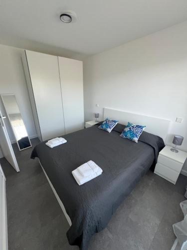 a bedroom with a large bed with two towels on it at Apartment Cluj, Baciu-Hills in Baciu