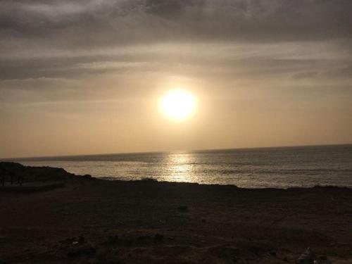 a sunset over the ocean with the sun in the sky at Vue ocean Almadies 300m2 3CH avec SDB Clim WiFi in Dakar