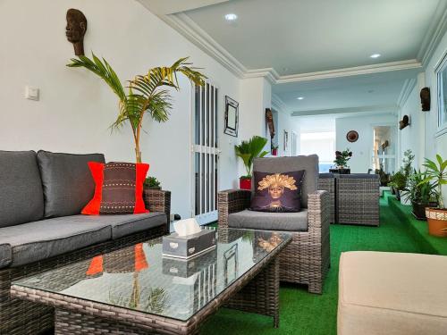 a living room with a couch and a coffee table at Vue ocean Almadies 300m2 3CH avec SDB Clim WiFi in Dakar