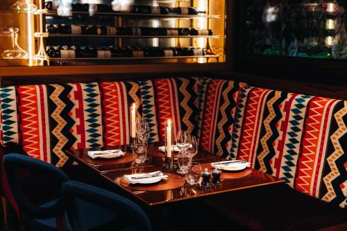 a couch with a table and candles on it at Maison Barrière Vendôme in Paris