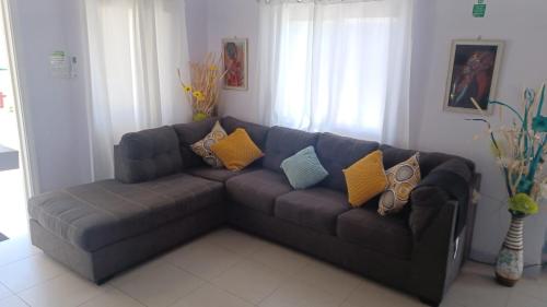 a couch with pillows on it in a living room at Summer Breeze Villa in Lucea