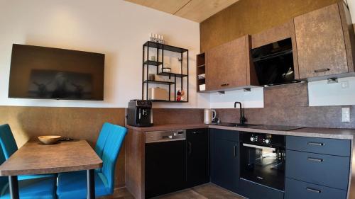 une cuisine avec des placards bleus et une table en bois dans l'établissement Apartment in Reutte, Austria, à Pflach