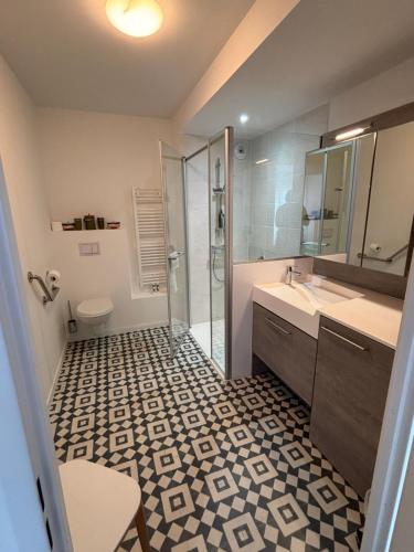 a bathroom with a shower and a sink and a toilet at Résidence Services Seniors DOMITYS - Villa Ulma in Lille