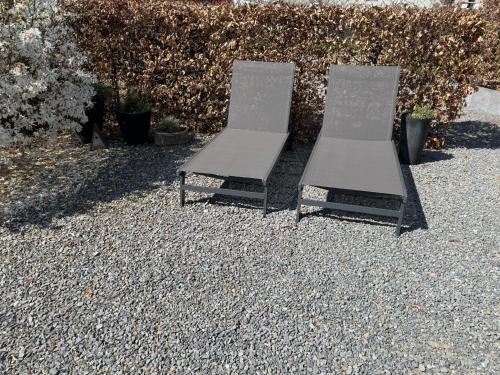 two chairs sitting on top of a pile of gravel at Country house Au Ballet des Hirondelles in Herve