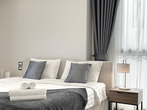 a bedroom with a large bed with towels on it at Circle31 #2BR Bangkok in Bangkok