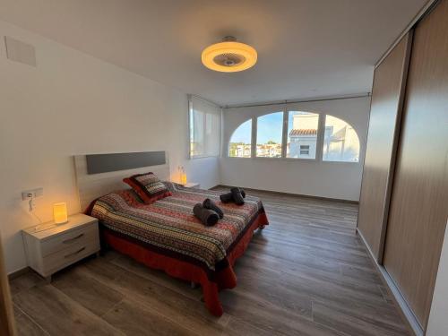 a bedroom with a bed and a large window at Bungalow Noa in Calpe