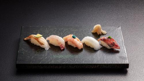 a group of peeled mushrooms on a plate at HOTEL AO Kanazawa in Kanazawa