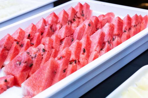 a white plate with a bunch of watermelon at Nikkey Palace Hotel in Sao Paulo