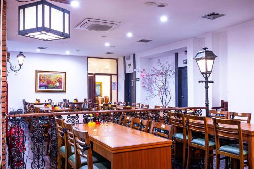 a dining room with wooden tables and chairs at Nikkey Palace Hotel in Sao Paulo
