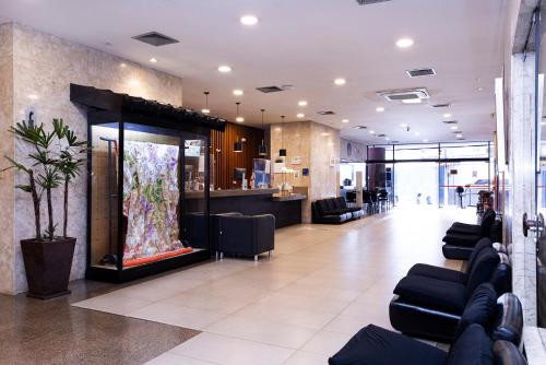 a lobby with a store with couches and a counter at Nikkey Palace Hotel in Sao Paulo
