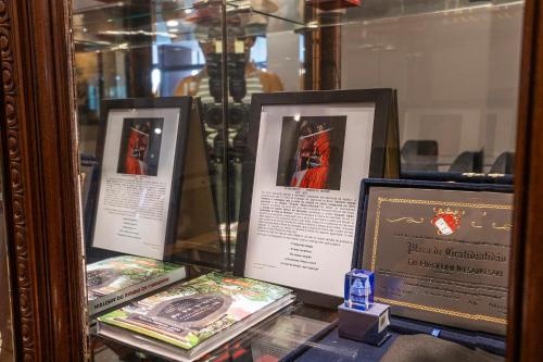 three framed books on display in a glass case at Nikkey Palace Hotel in Sao Paulo