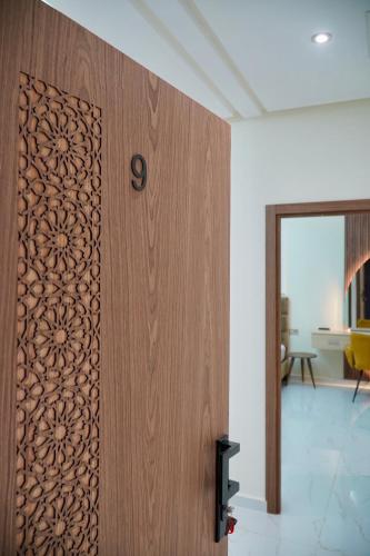 a wooden door with a design on it in a room at Les portes de Temara in Temara