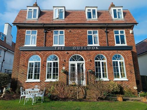 an old brick building with a table in front of it at The Outlook Scarborough in Scarborough